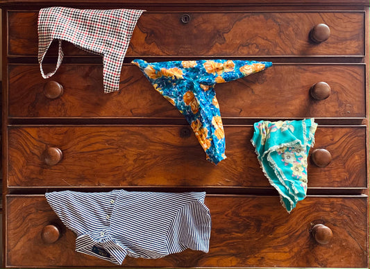 Clothes hanging out of drawers