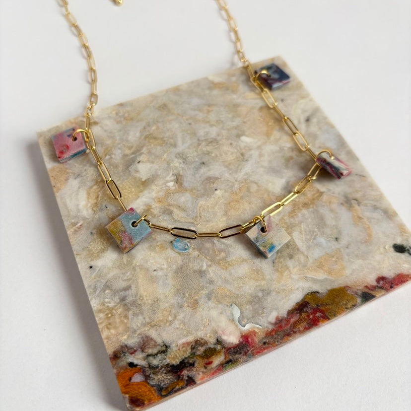 Statement necklace with chunky square pendants made from recycled textiles using Fabreco, a sustainable material.