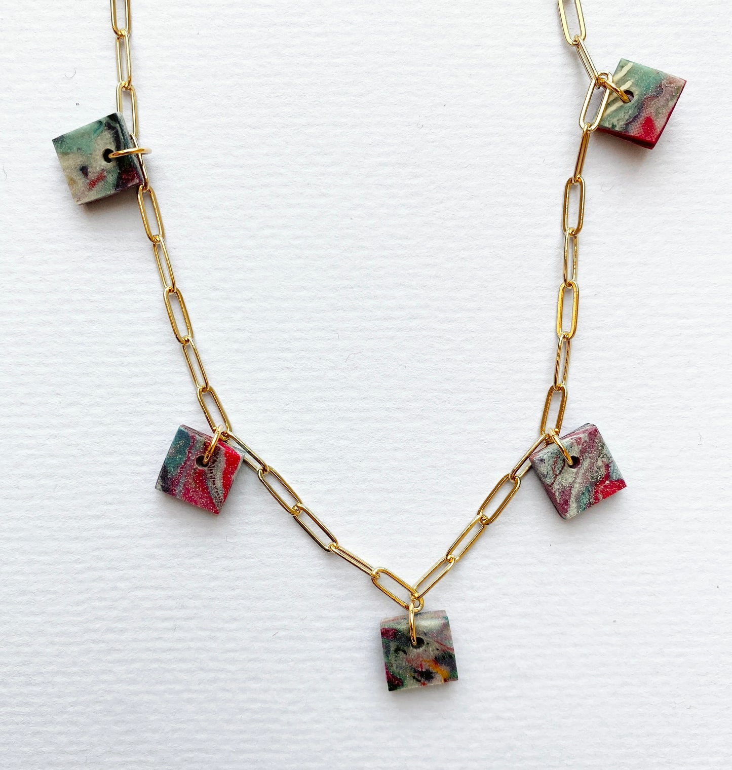 Statement necklace with chunky square pendants made from recycled textiles using Fabreco, a sustainable material.