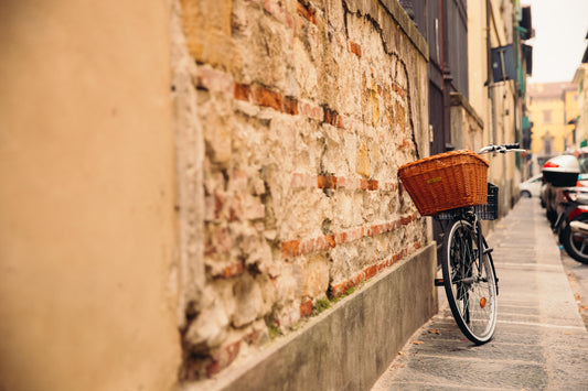 Bike leaning on brick wall in city street