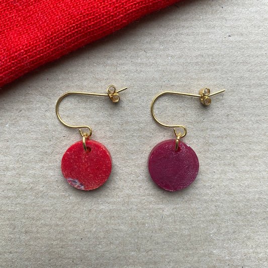 Handmade round dangle earrings crafted from upcycled Fabreco in deep red and crimson hues with gold-plated hooks, sustainable fashion accessory.